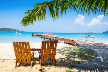 Two beach chairs on idyllic tropical sand beach.