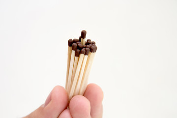 A man holds a match in his hand