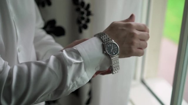Man put on wrist watches closeup