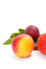 Freshly washed peach  on wooden cutting board isolated on white background