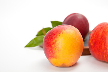 Freshly washed peach  on wooden cutting board isolated on white background