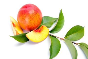fresh peach fruits with green leaves isolated on white background
