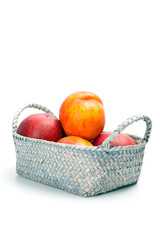 Ripe fresh nectarines in the wicker basket isolated on a white background
