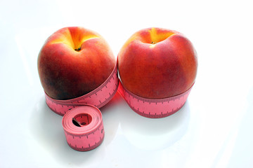 Menu diet plan or program, tape measure, and diet food fresh fruits on a white background. Weight loss and the concept of detoxification.