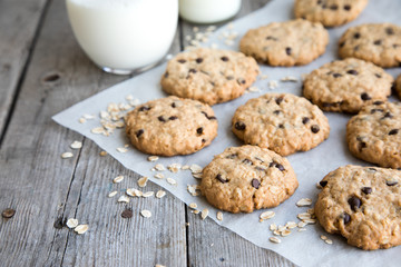 oatmeal cookies with chocolate on an old wooden background