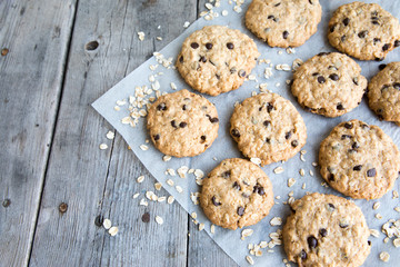 oatmeal cookies with chocolate on an old wooden background