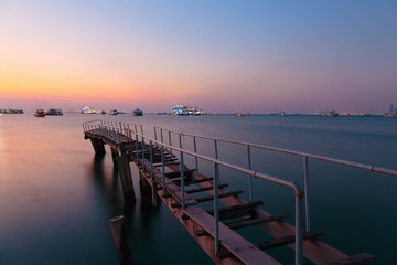 Fototapeta premium Old rusty pier on the island at sunset