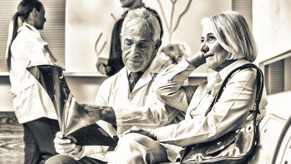 Doctors and patient discussing in hospital waiting room