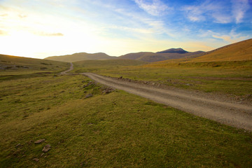 Escape to the Pyrenees from dawn to dusk Set of panoramic images of the Pyrenees from the sunrise to the sunset, where we can appreciate: meadows, mountains, rivers, villages, houses.