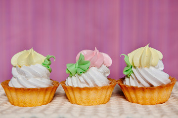 Cupcakes on pink background with copy space