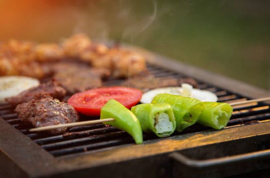 Bbq. Meat, peppers and tomato fry on the grill.