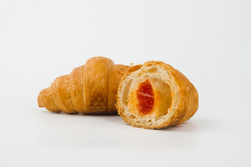 Delicious croissants with cherry jam on a white background