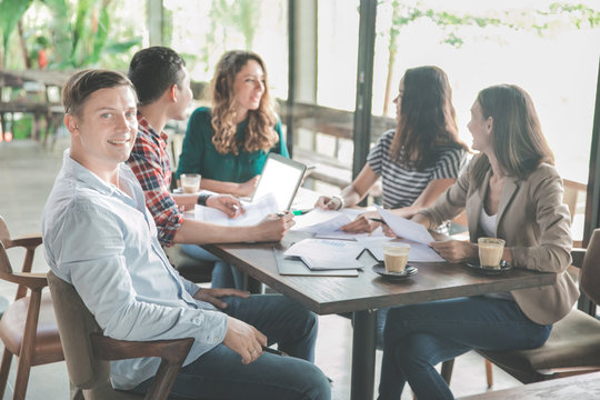 attractive businessman and his team during meeting in a coffee s