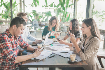 business people busy on their gadget during team meeting