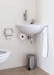 Hydrant and sink in a small toilet