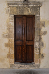 Fototapeta na wymiar A dark wooden door on a stony wall