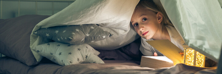 Girl hiding under the covers