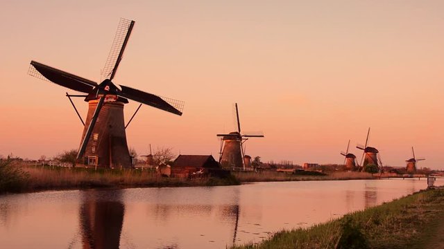 The picturesque landscape with aerial mills on the channel in Kinderdiyk, Netherlands at sunset. Full HD video. Retro style. (relaxation, meditation, stress reduction - concept)
