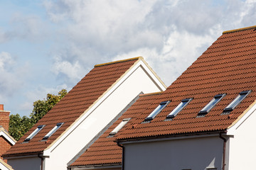 Skylight attic windows on modern clay tile roof.