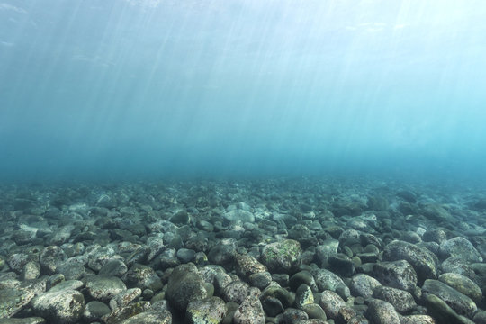 Black volcanic rocks at the bottom of the sea in bali