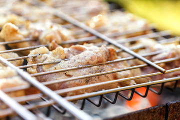 Chicken meat fried on a barbecue grill.