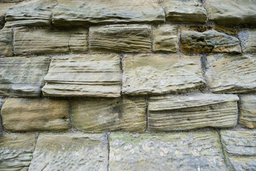 Textured grey coloured brick wall close up