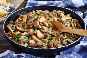 fried porcini with parsley in skillet - Powered by Adobe