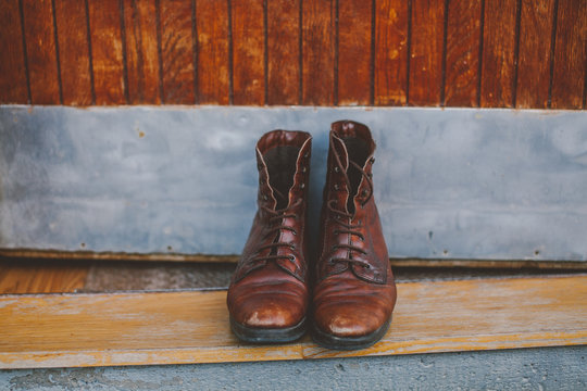 Vinage brown laced  up boots in front of old doors