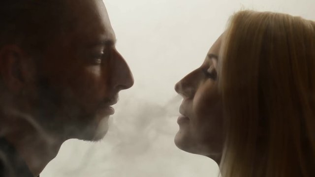 Woman gives smoke kiss to man. Vape culture