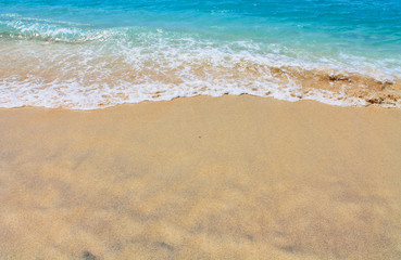 Fototapeta na wymiar Sand and blue sea, Waves breaking on beach.