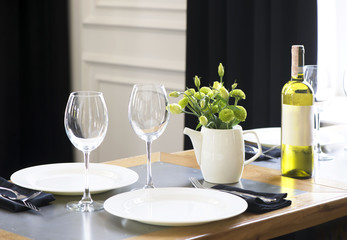 the table in the restaurant is served with white dishes