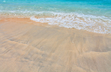 Fototapeta na wymiar Sand and blue sea, Waves breaking on beach.