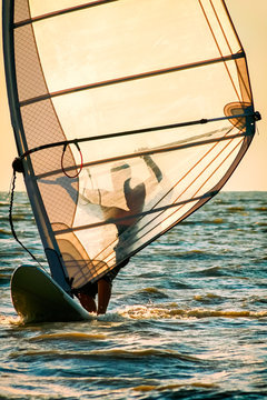 Windsurfing on sunset background, close-up