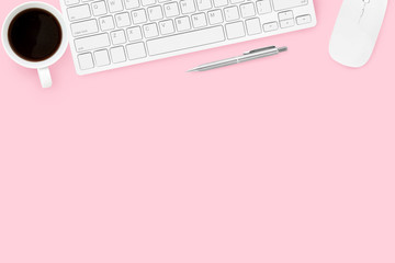 Pink pastel woman office desk with computer gadgets, coffee and pen. Top view with copy space, flat lay.