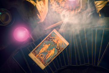 Tarot card / View of tarot card on the table under candlelight. The Lover. Dark tone. - obrazy, fototapety, plakaty