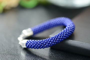 Dark blue beaded bracelet on a dark background