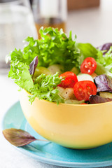 Fresh salad with mixed greens and cherry tomato in bowl