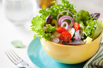 Fresh salad with mixed greens and cherry tomato in bowl