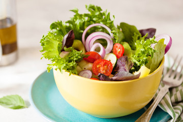 Fresh salad with mixed greens and cherry tomato in bowl