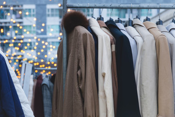 Winter coats hanged on a clothes rack.