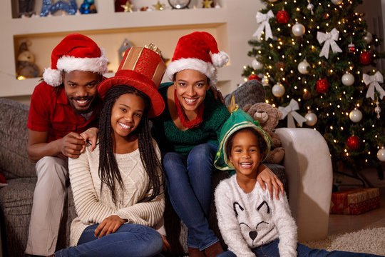 Portrait Of Afro American Family In Santa Hats On Christmas.