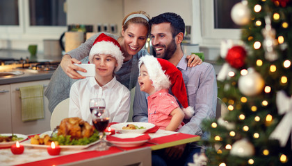 smiling family taking selfie for Christmas.
