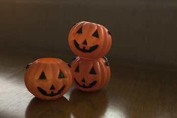 Three halloween pumpkin baskets on the table focused on the back two