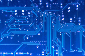 Blue, dusty computer circuit board.