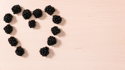 Fresh berries of blackberry in form heart