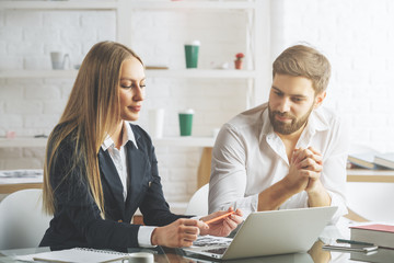 White man and woman working on project