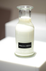 milk in a clear bottle on a white cubicle
