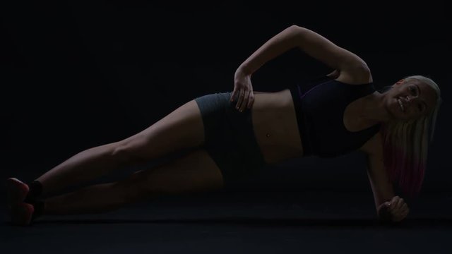  Fit young woman doing exercises to improve core strength