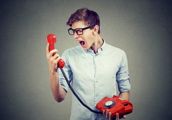 Young man screaming on the phone