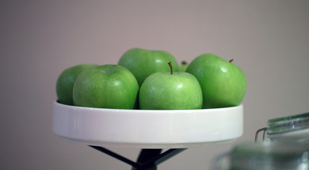 bright green apples on a white tray